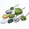 A collection of twelve silk leaf artificial plant stems in various shades of green and gray.