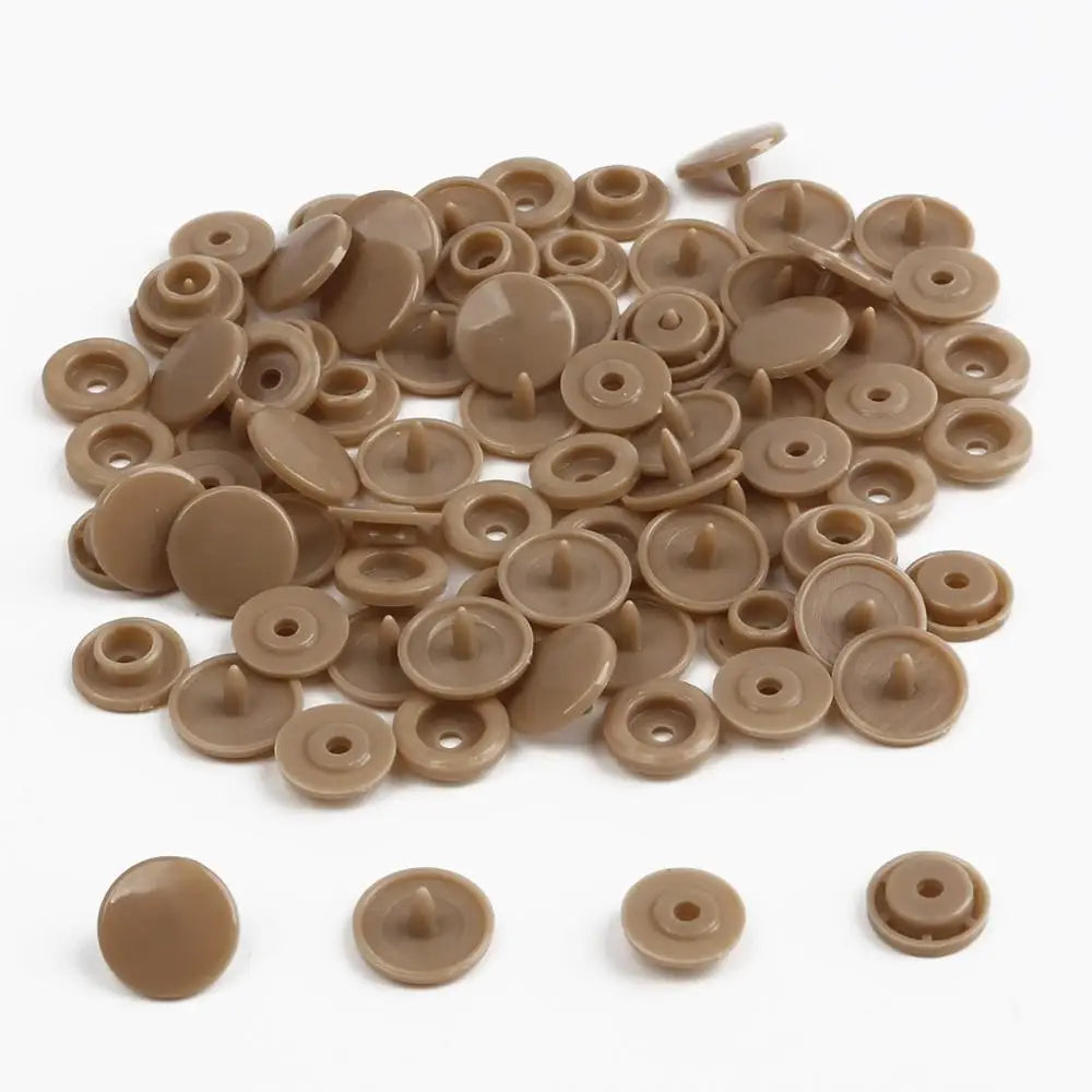 A pile of assorted tan and beige snap buttons, measuring 12mm and 10.5mm, for crafting.