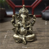 Handcrafted gold resin statue of Ganesha sitting in a meditative pose