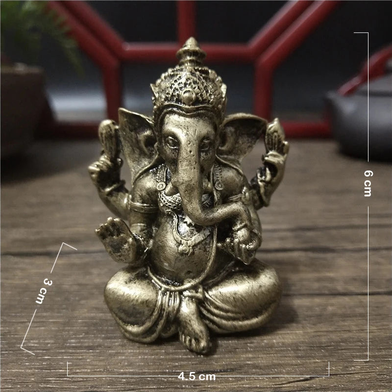 Handcrafted gold resin statue of Ganesha sitting in a meditative pose