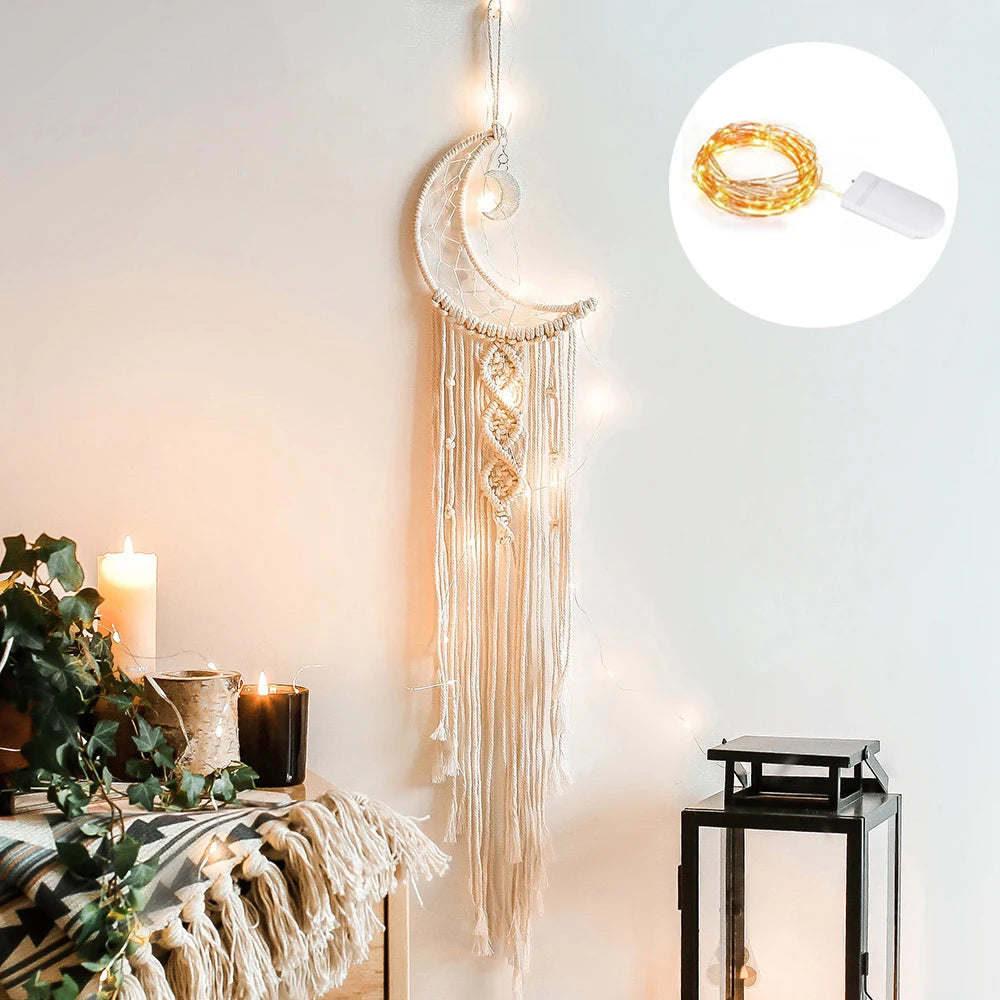 Boho macrame dream catcher wall decor featuring a crescent moon and fringe hanging on a white wall.
