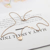 A delicate gold-toned necklace featuring a heart lock key pendant on a thin chain, displayed on a white background.