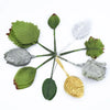 A collection of twelve silk leaf artificial plant stems in various shades of green, gray, and gold.