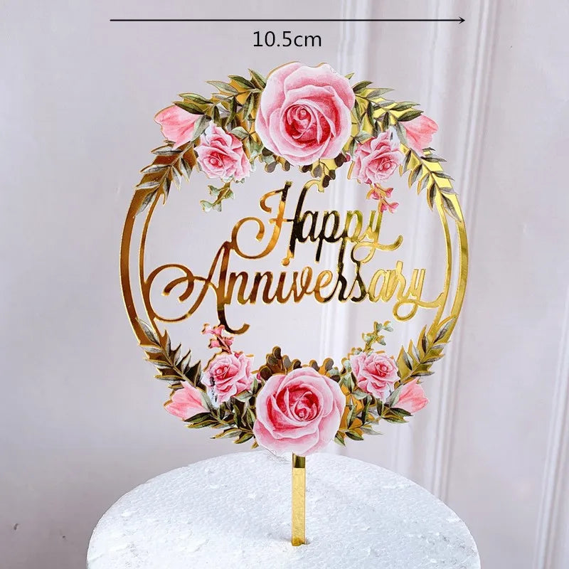 Rose gold acrylic wreath with pink roses and happy anniversary text on a gold stick