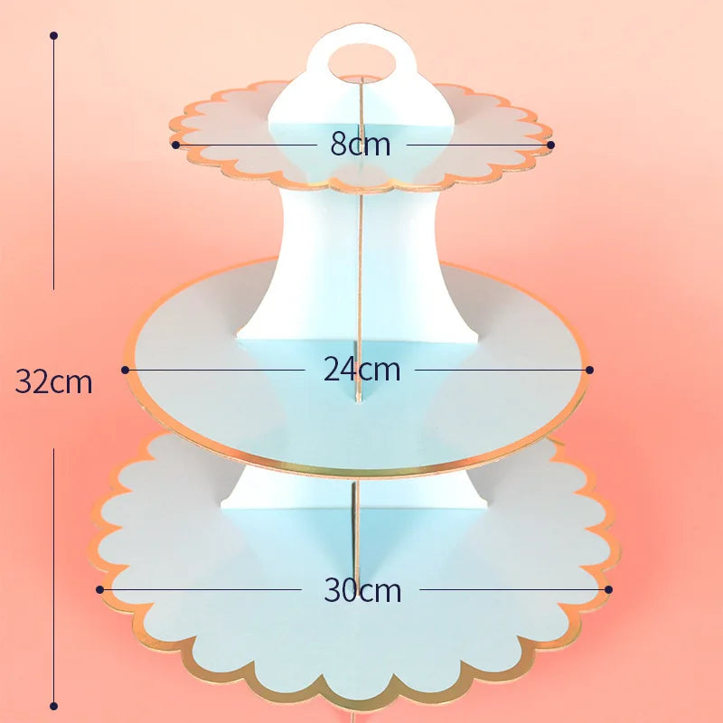 A three-tier cardboard cupcake stand with a light blue color and gold accents, showing its dimensions.