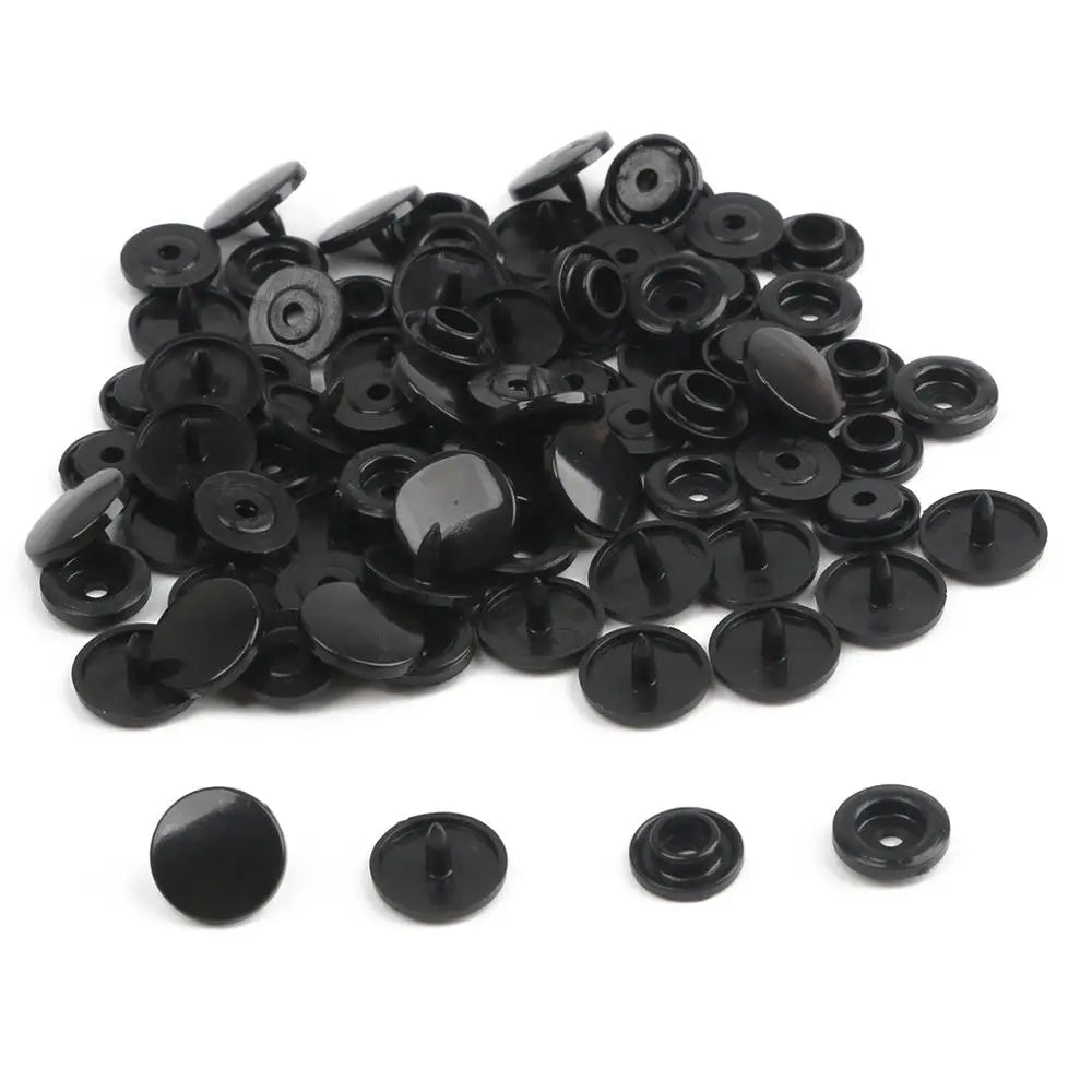 A pile of assorted black snap buttons measuring 12mm and 10.5mm for crafting.