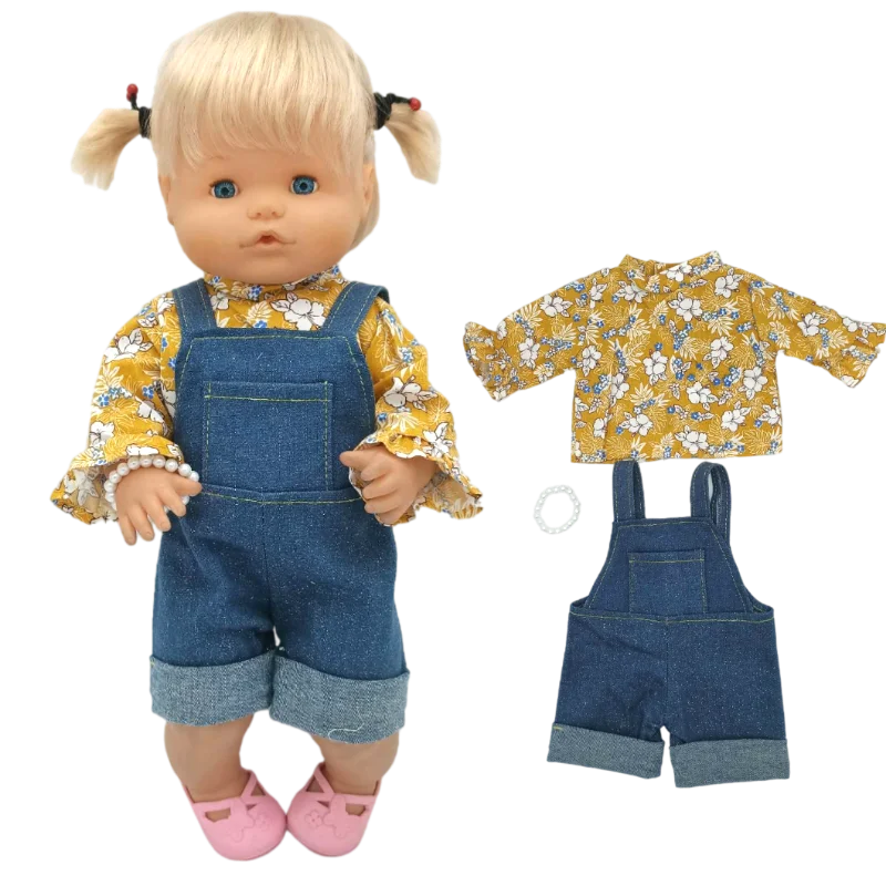A blonde doll wearing a yellow floral top and denim overalls with pink shoes, accompanied by the outfit pieces.
