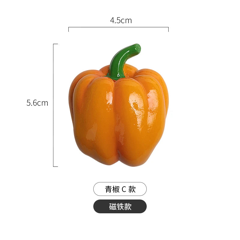 A realistic orange bell pepper with a green stem, used as a fridge magnet.