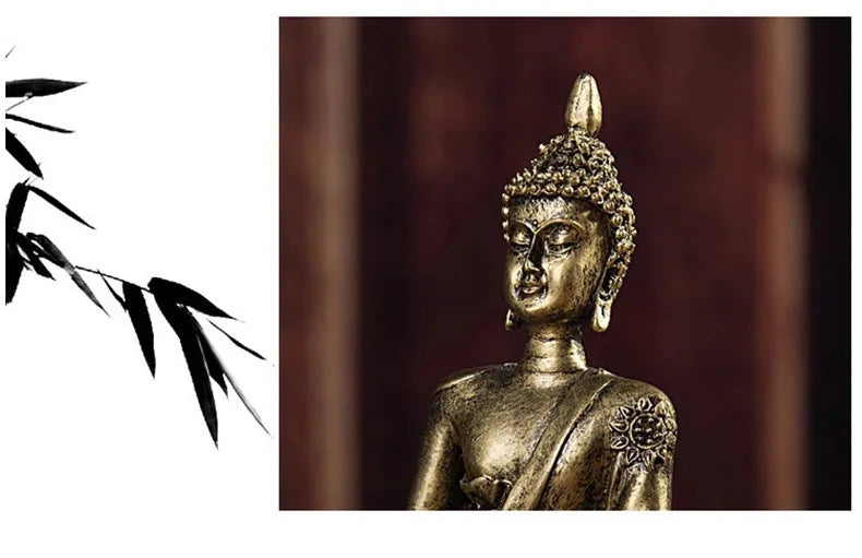 A close-up of a golden Buddha statue with intricate details, set against a dark wooden background.