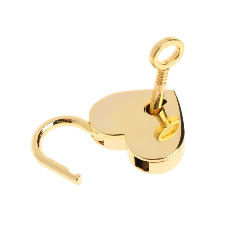 A vintage heart-shaped mini padlock with a key, made of gold-toned metal.