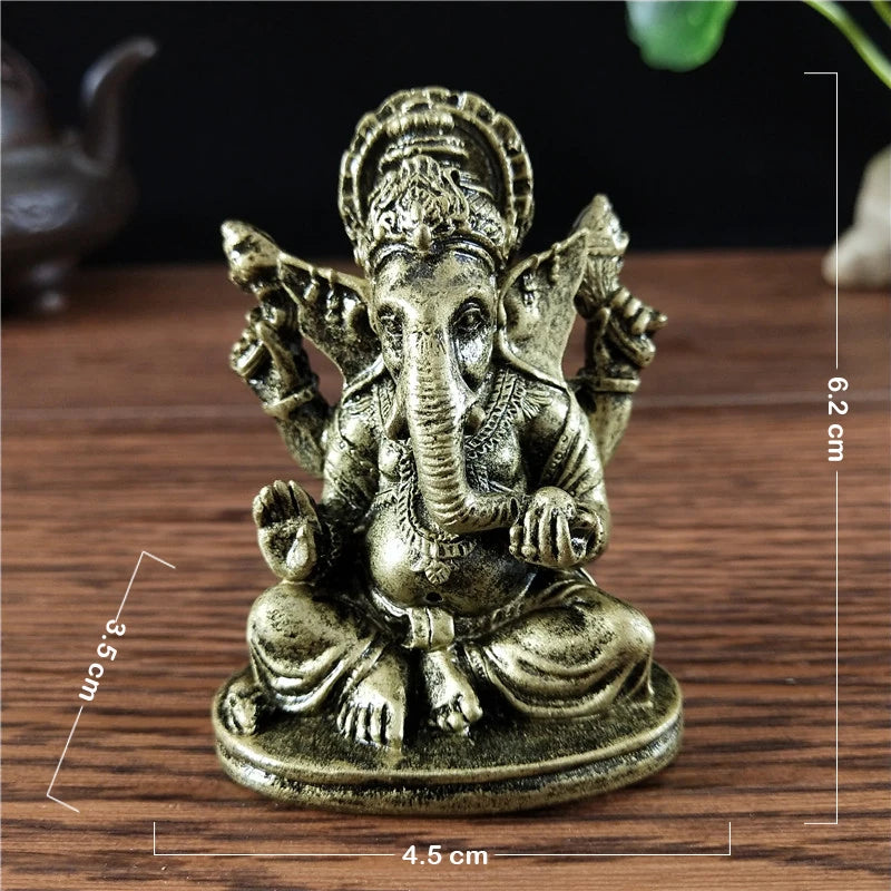 Gold Ganesha statue handcrafted resin figurine sitting on a wooden surface.