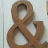 A pair of vintage wooden alphabet letters, an ampersand (&), used for home decor or events.