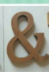 A pair of vintage wooden alphabet letters, an ampersand (&), used for home decor or events.