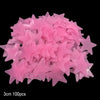A pile of pink glow-in-the-dark star and moon wall stickers.