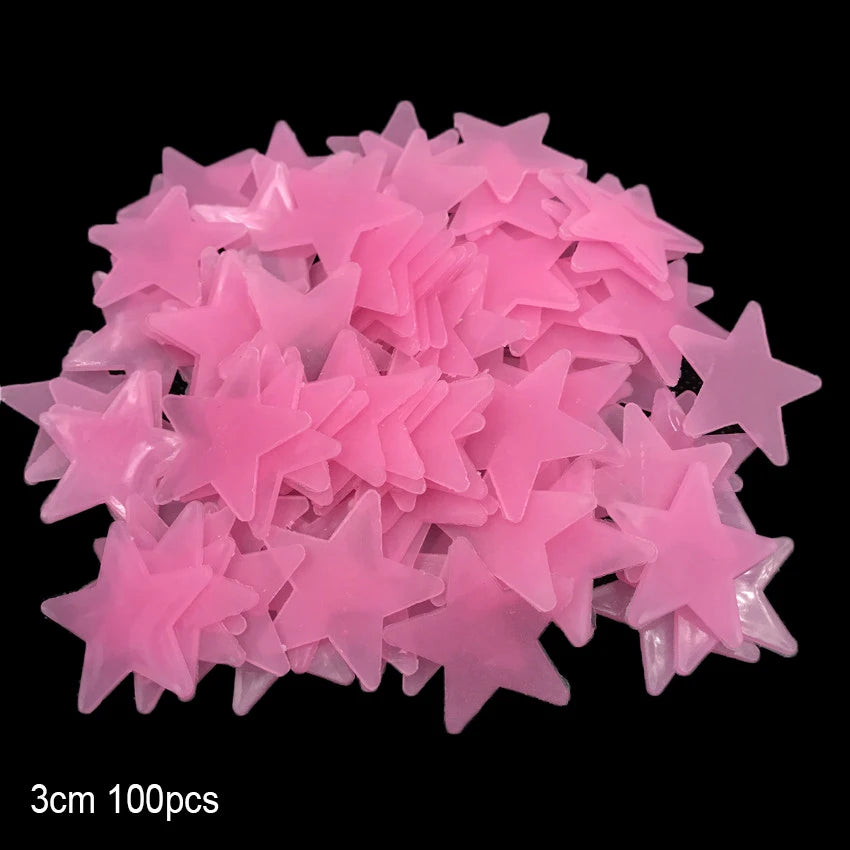 A pile of pink glow-in-the-dark star and moon wall stickers.