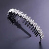 A sparkling crystal rhinestone headband for women displayed against a dark gray background.