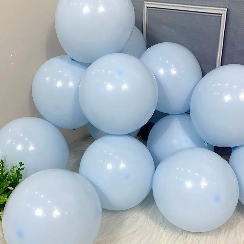 A collection of light blue pastel candy balloons arranged on a surface.