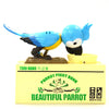 A collectible parrot figurine named Tori-Bako, a blue bird with yellow accents, standing on a yellow base.