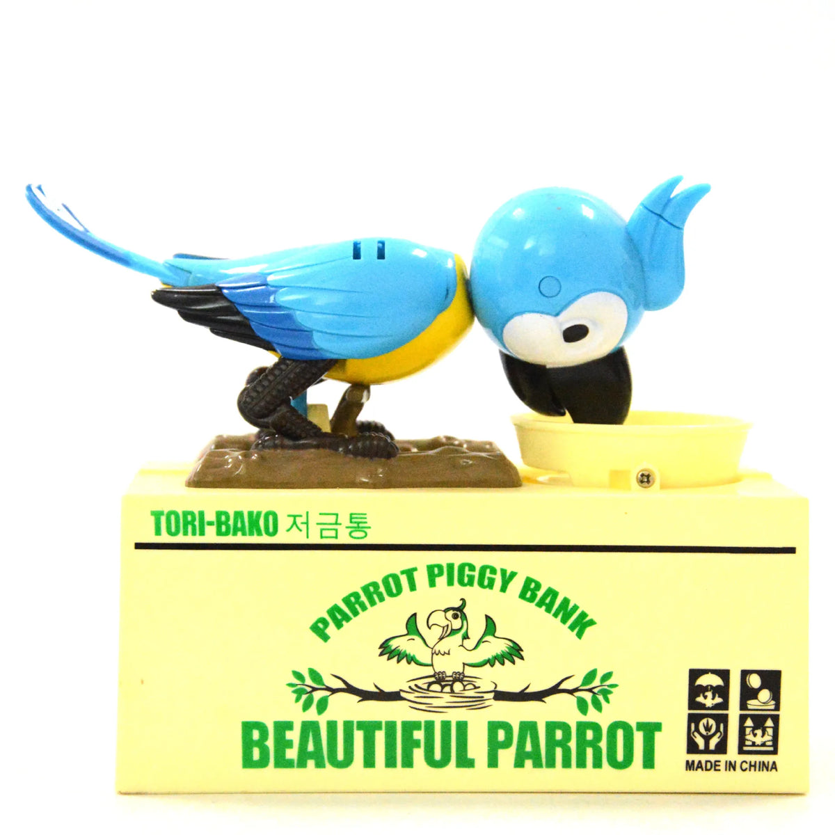 A collectible parrot figurine named Tori-Bako, a blue bird with yellow accents, standing on a yellow base.
