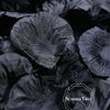 A close-up shot of dark black silk rose petals for weddings and events.