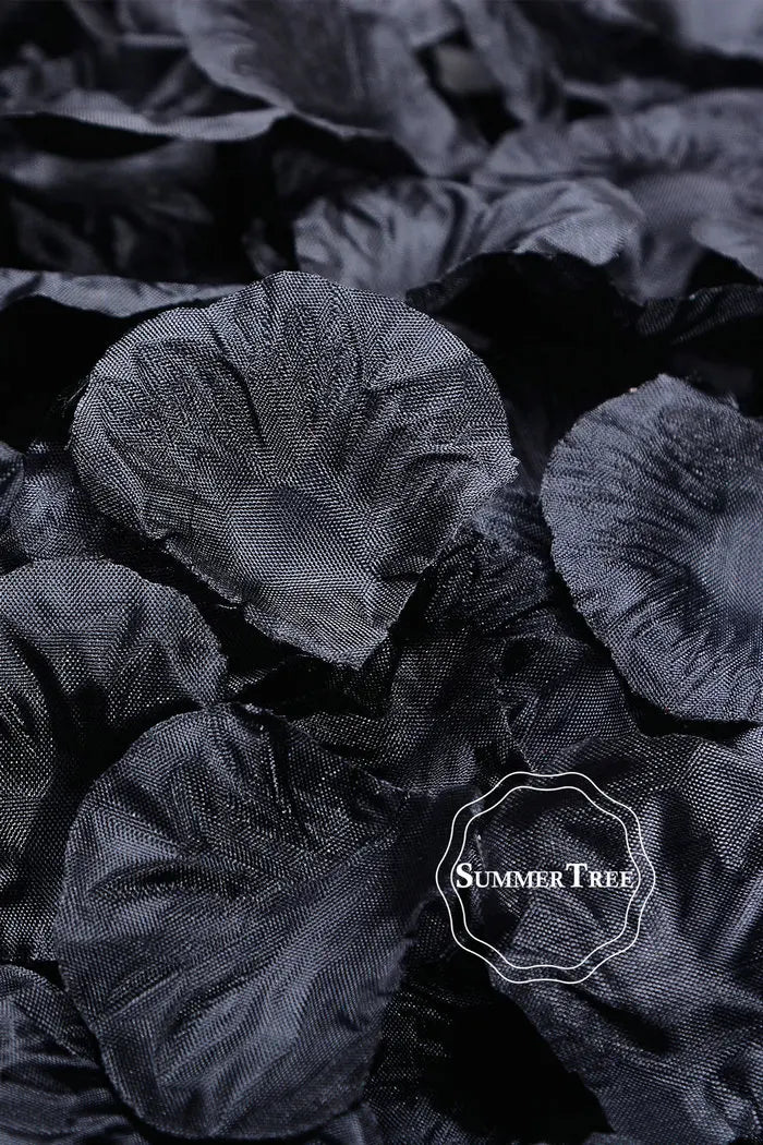 A close-up shot of dark black silk rose petals for weddings and events.