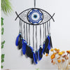 Handmade boho evil eye dream catcher wall decor featuring a black and blue spiderweb design with dangling feathers