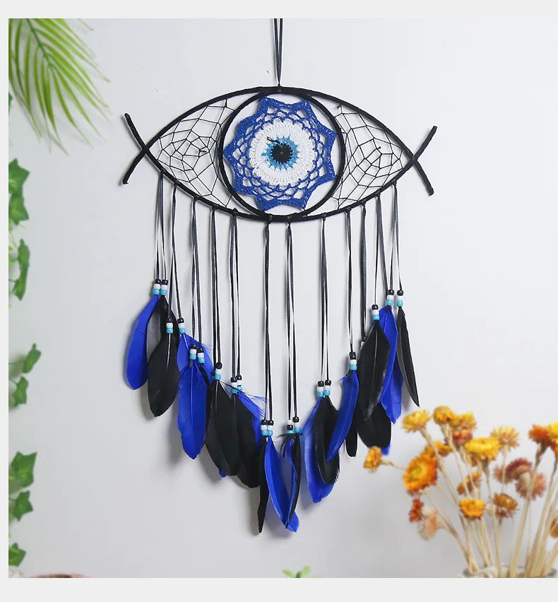 Handmade boho evil eye dream catcher wall decor featuring a black and blue spiderweb design with dangling feathers