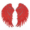 A pair of large, textured red sequin wing patches for DIY sewing or iron-on embellishment.