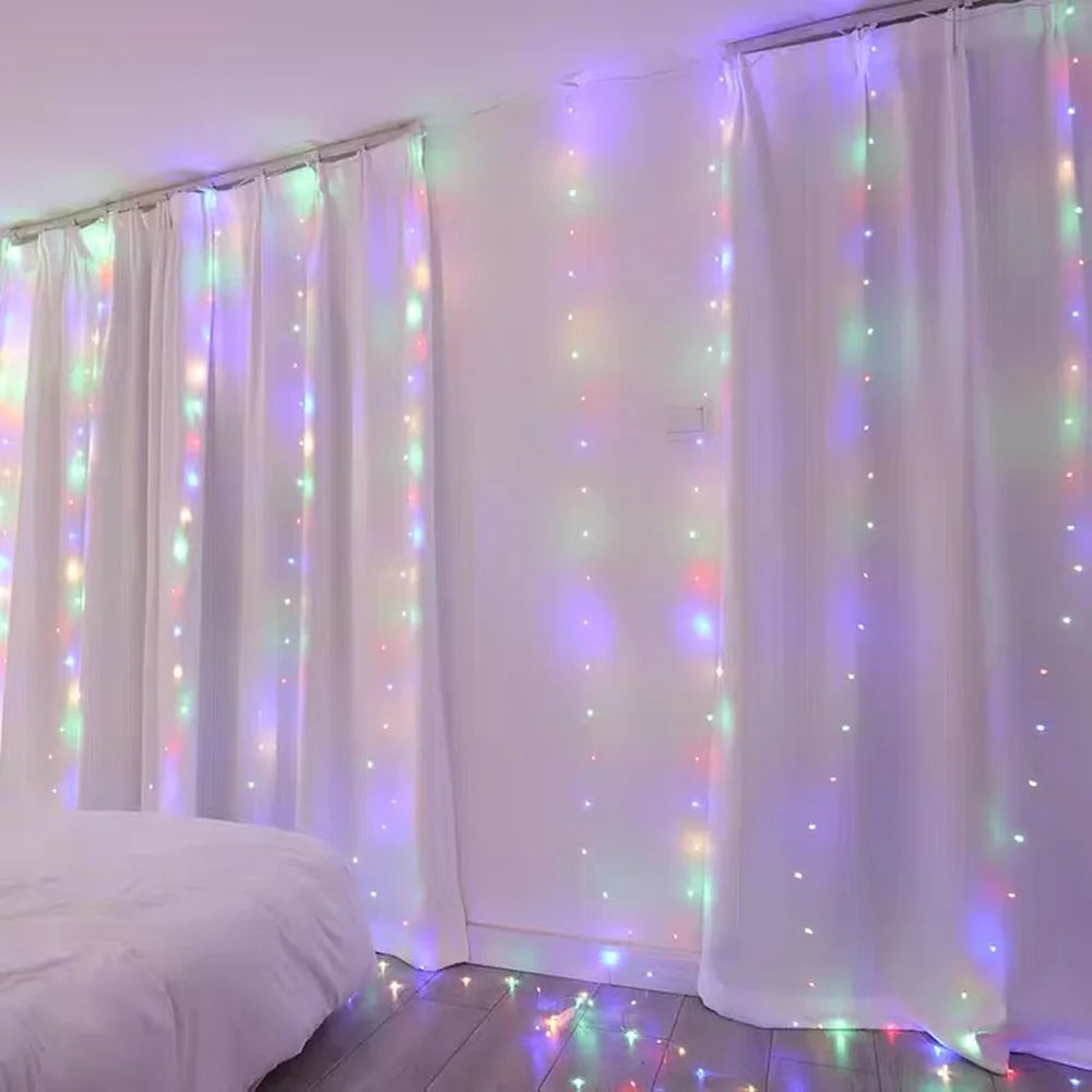 White sheer curtains illuminated by colorful LED string lights in a room setting
