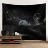 A dark tapestry depicting a moon and stars over a landscape with an old radio on a wooden shelf.