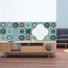 A decorative wall featuring blue and teal mandala tile stickers on a light blue background above a wooden cabinet.
