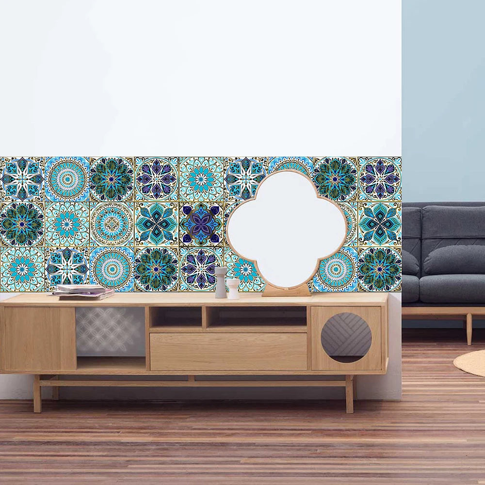 A decorative wall featuring blue and teal mandala tile stickers on a light blue background above a wooden cabinet.