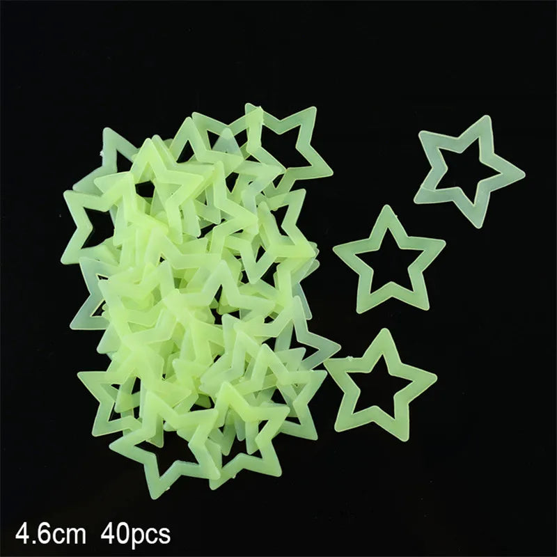 A pile of light green glow-in-the-dark star and moon wall stickers.