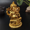 Gold Ganesha statue handcrafted resin figurine with a crown and ornate details.