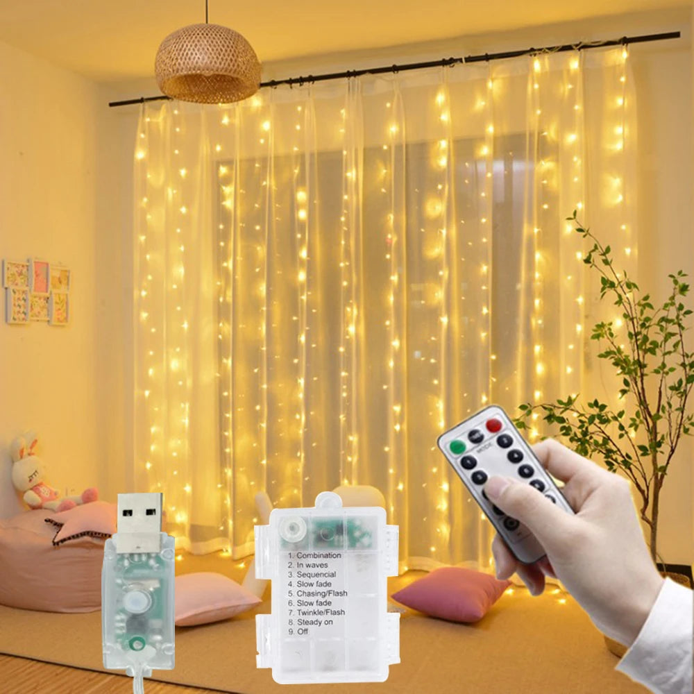A hand holds a remote control for LED curtain fairy lights, showing the light strings illuminating a sheer curtain.