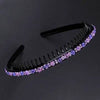 Black hairbrush with purple crystal rhinestones used as a headband