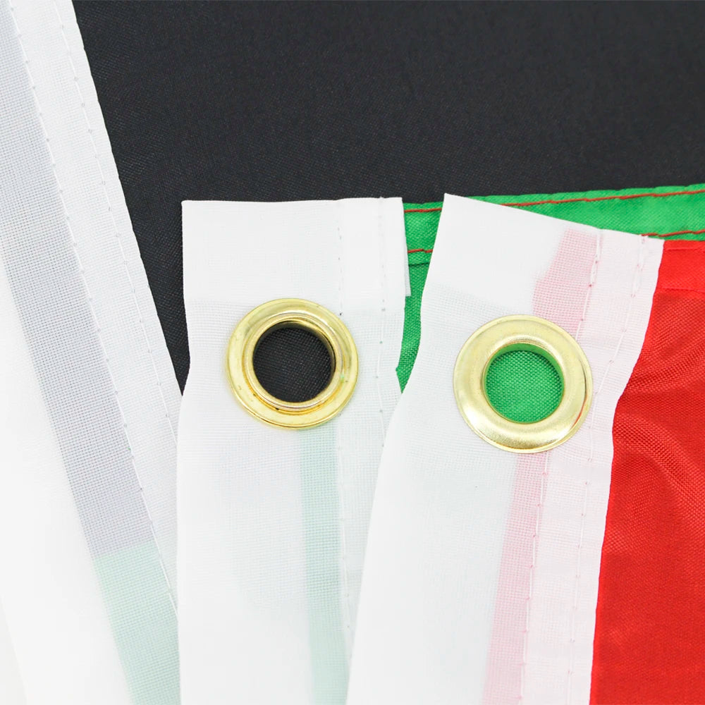 Close-up of a white flag with red and pink stripes, featuring gold grommets on the edge.