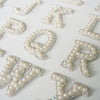 White rhinestone alphabet letters including K, P, Q, R, and V patches