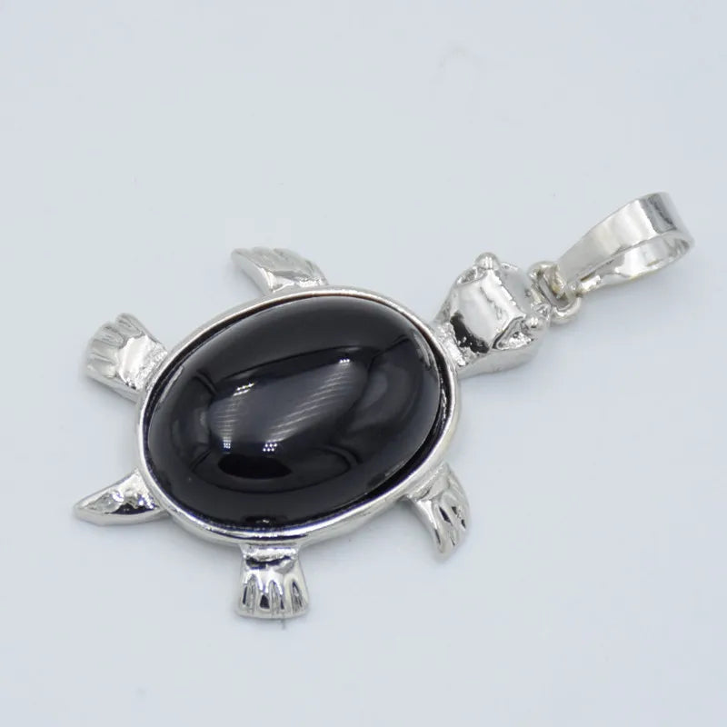 Silver pendant necklace featuring a polished black oval natural stone shaped like an animal.