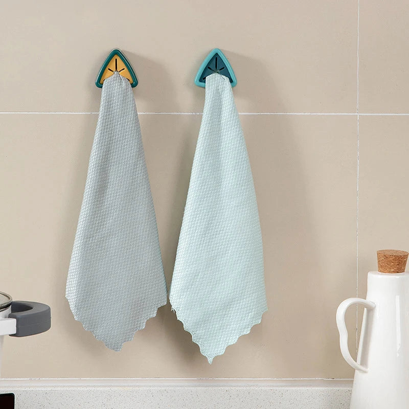 Light blue cloth towel hanging on a wall hook, used for drying or storage.