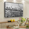 Black and white canvas wall art depicting a cityscape skyline with people on a train.