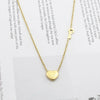 A gold-colored titanium steel heart lock key pendant necklace with a chain and a charm.