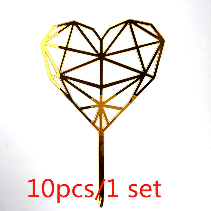 A gold acrylic heart-shaped cake topper with a geometric design on a stick.