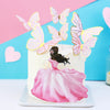 A white cake decorated with pink and yellow butterfly toppers and a large pink floral fondant skirt.