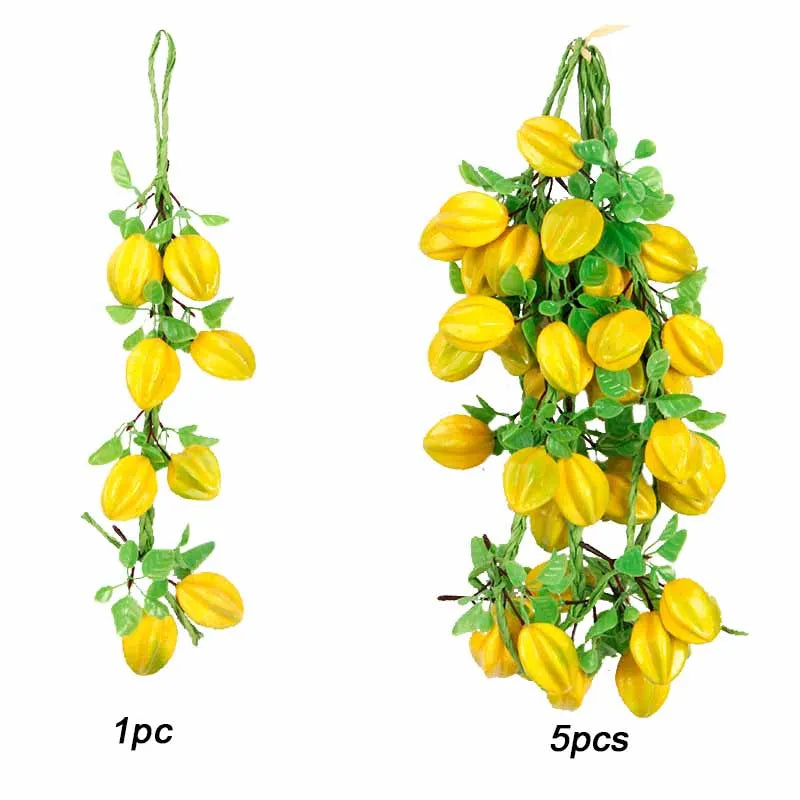A bundle of artificial yellow fruits and vegetables, including peppers and small gourds, used for decoration.