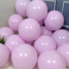 A cluster of light pink pastel candy balloons arranged on a surface.