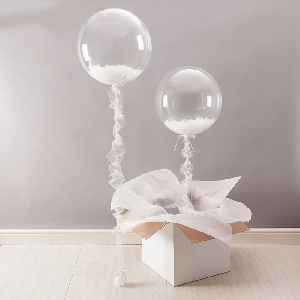 Clear bobo balloons with white filling tied on strings displayed on a white box