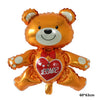 Globo de aluminio naranja con forma de oso de peluche y un corazón rojo en el pecho.