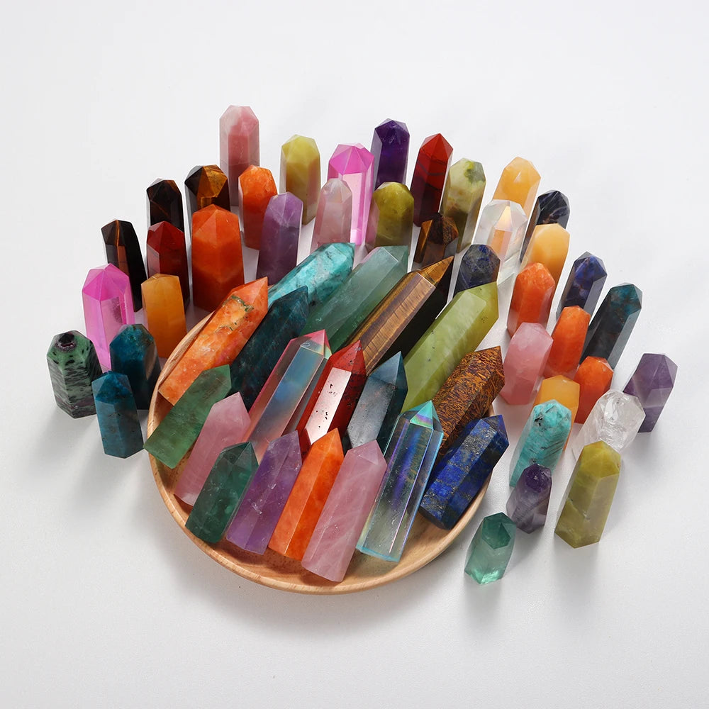A collection of colorful natural crystal points and prisms arranged in a tower for meditation or home decor.