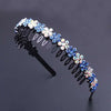 A black headband decorated with blue and white crystal rhinestones.